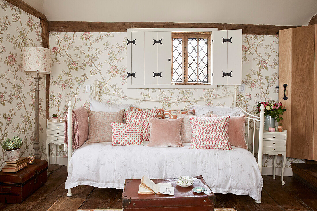 Daybed with Indienne wallpaper below window with shutters in Grade II listed farmhouse Kent, UK