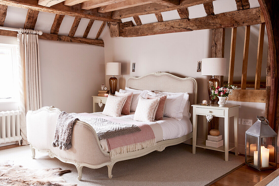 French antique bed at window of beamed Grade II listed farmhouse Kent, UK