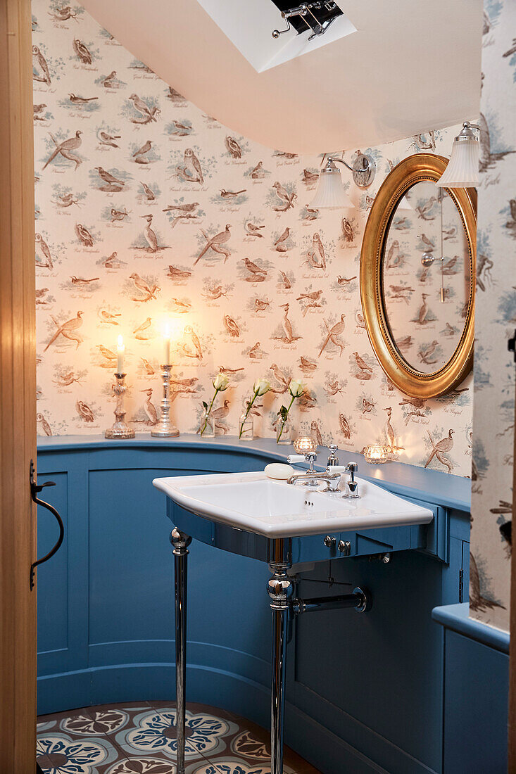 Curved panelling with Bewick Birds wallpaper in cloakroom of Grade II listed farmhouse Kent, UK