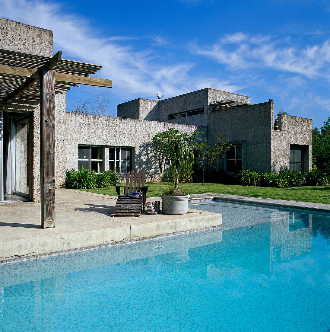 Facade of textured concrete building with swimming pool