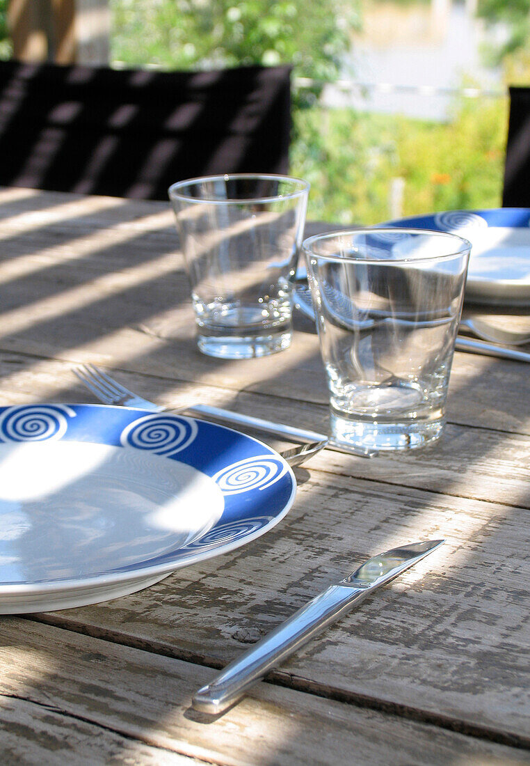 Place setting with glasses on shaded table