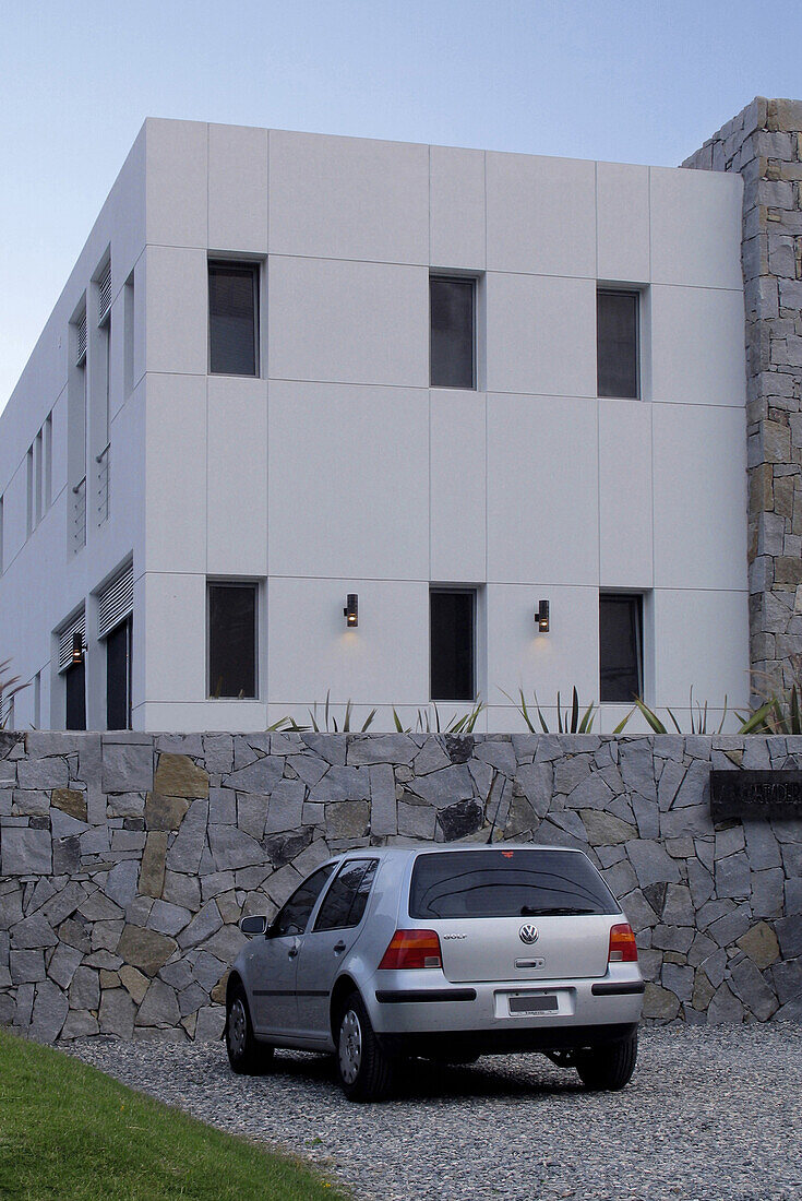 Hausfassade mit geparktem Auto in der Einfahrt