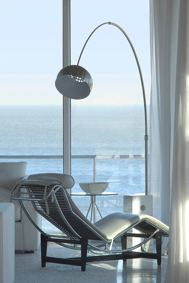 20. Jahrhundert Design-Liegestuhl am Fenster mit Metalllampe und Blick auf das Meer
