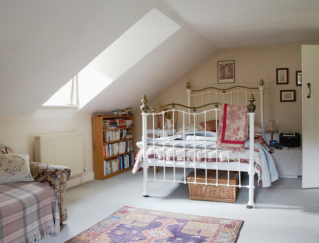 Spacious attic bedroom in country house with dormer windows