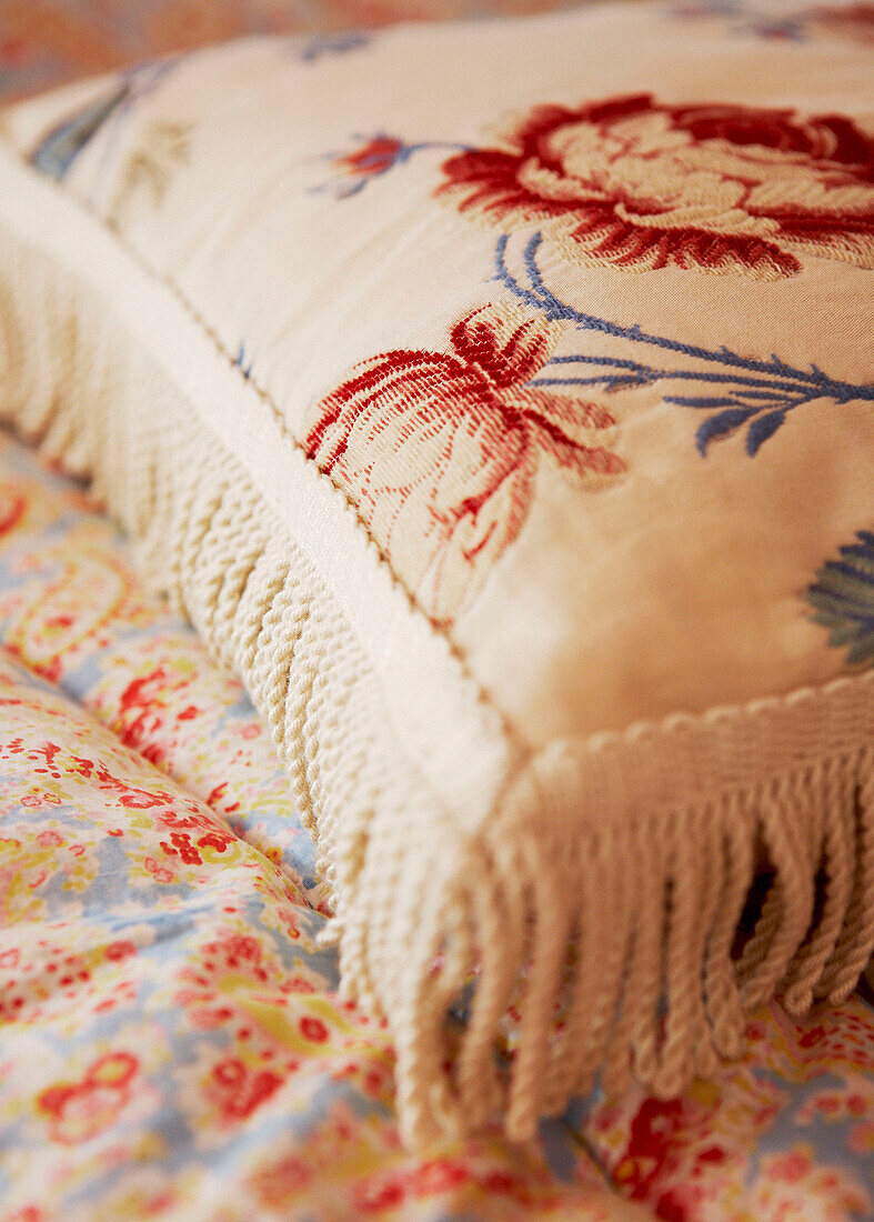 Embroidered cushion on quilt