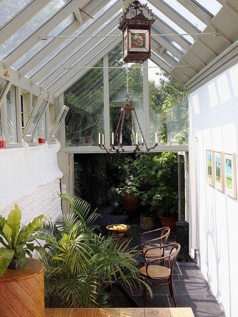 Sunlit conservatory with pitched glass roof