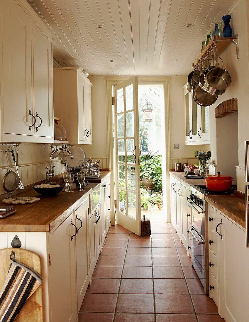 Narrow galley kitchen with door opening onto garden