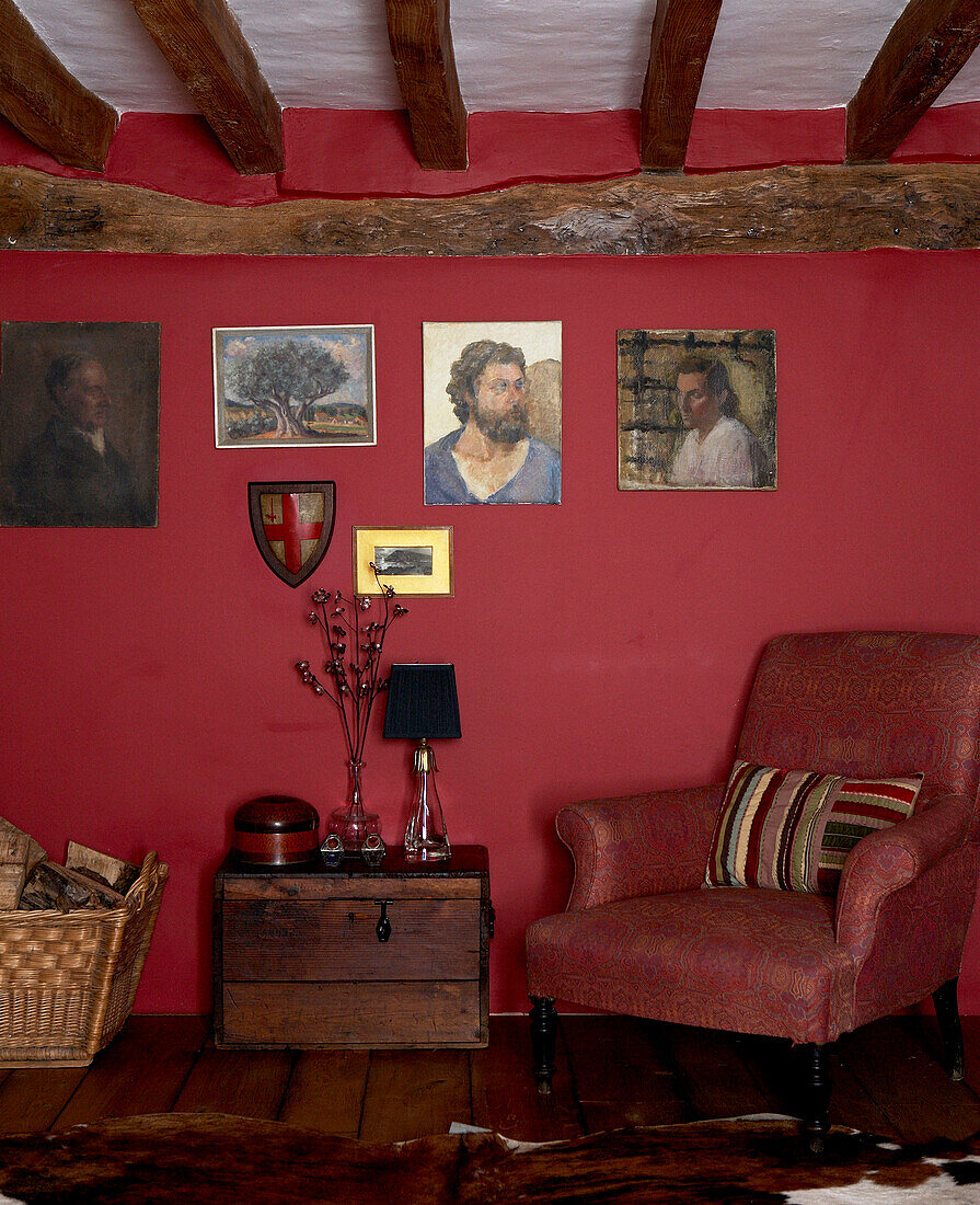 Beamed ceiling and dark red walls of 17th Century Oxfordshire living room
