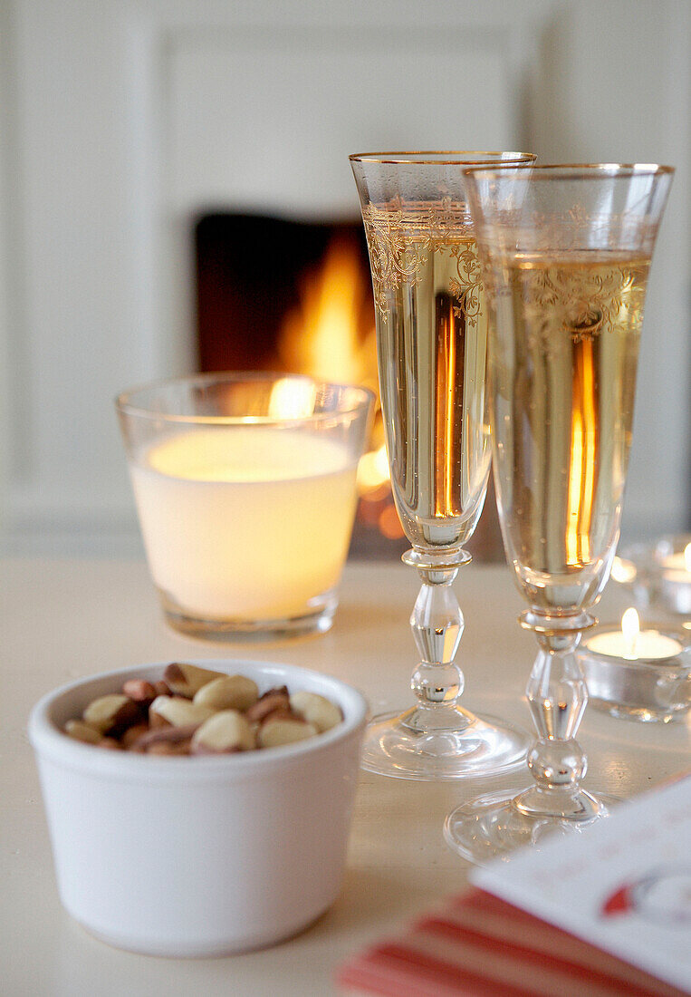 Champagne glasses on table with peanuts 