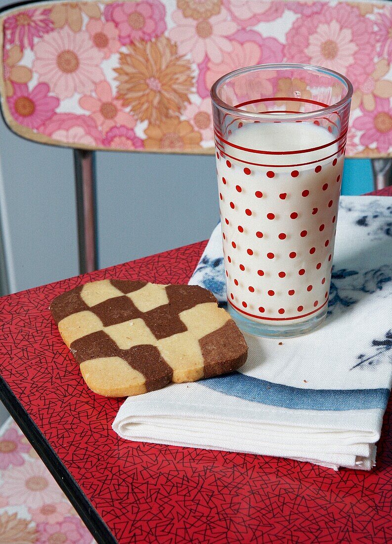 Milk and cookie on table of 1950s style kitchen
