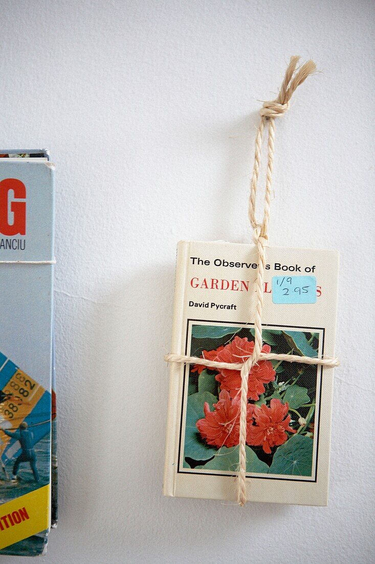 1950s style book hanging with rope on wall