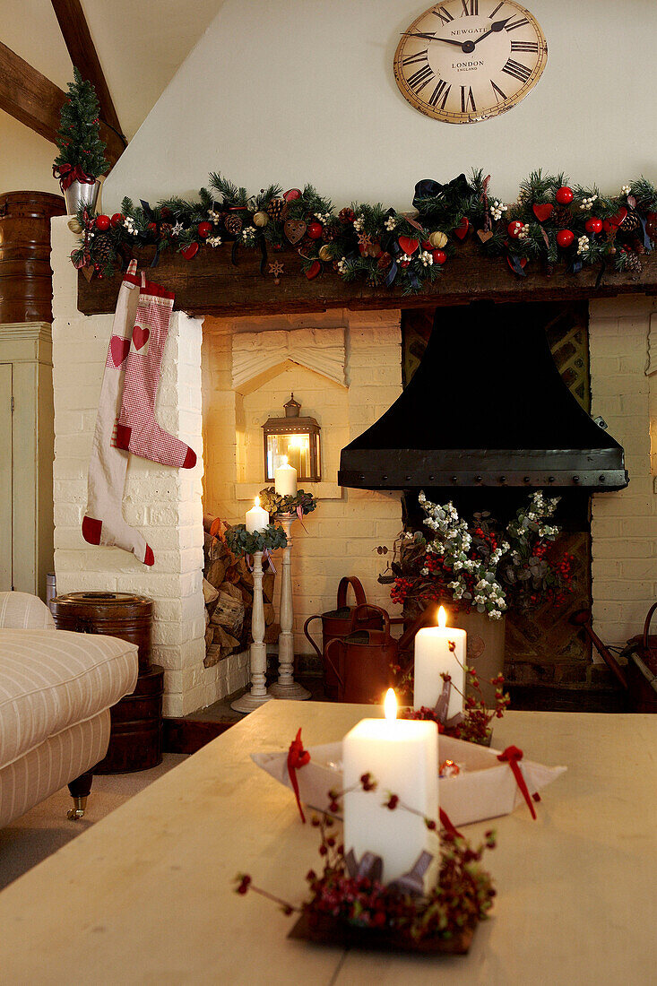 Christmas stockings on fireplace with floral garlands