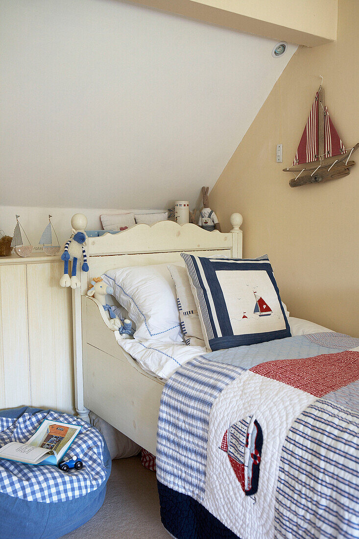 Painted single bed in boy's room with nautical theme
