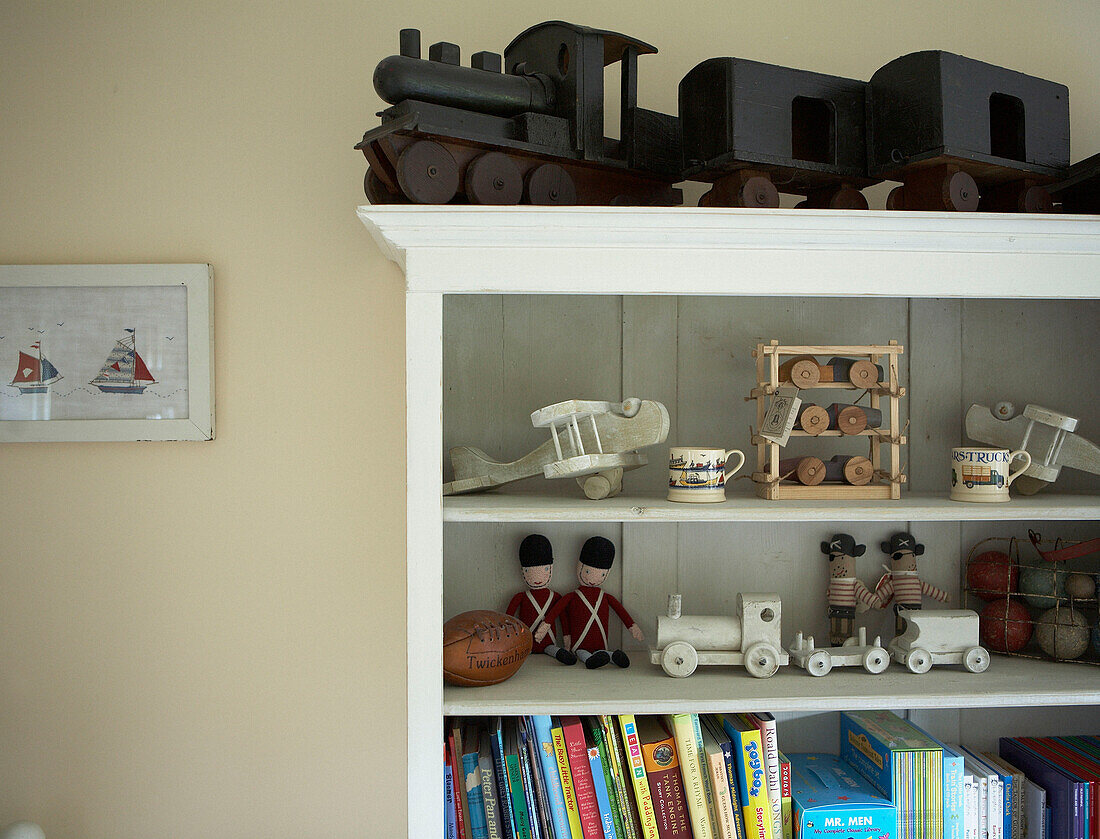 Wooden toys on shelving unit with books