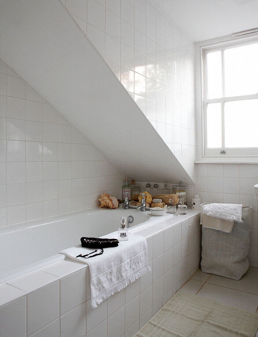 Under stairs bath in all white Grade II listed Georgian townhouse bathroom