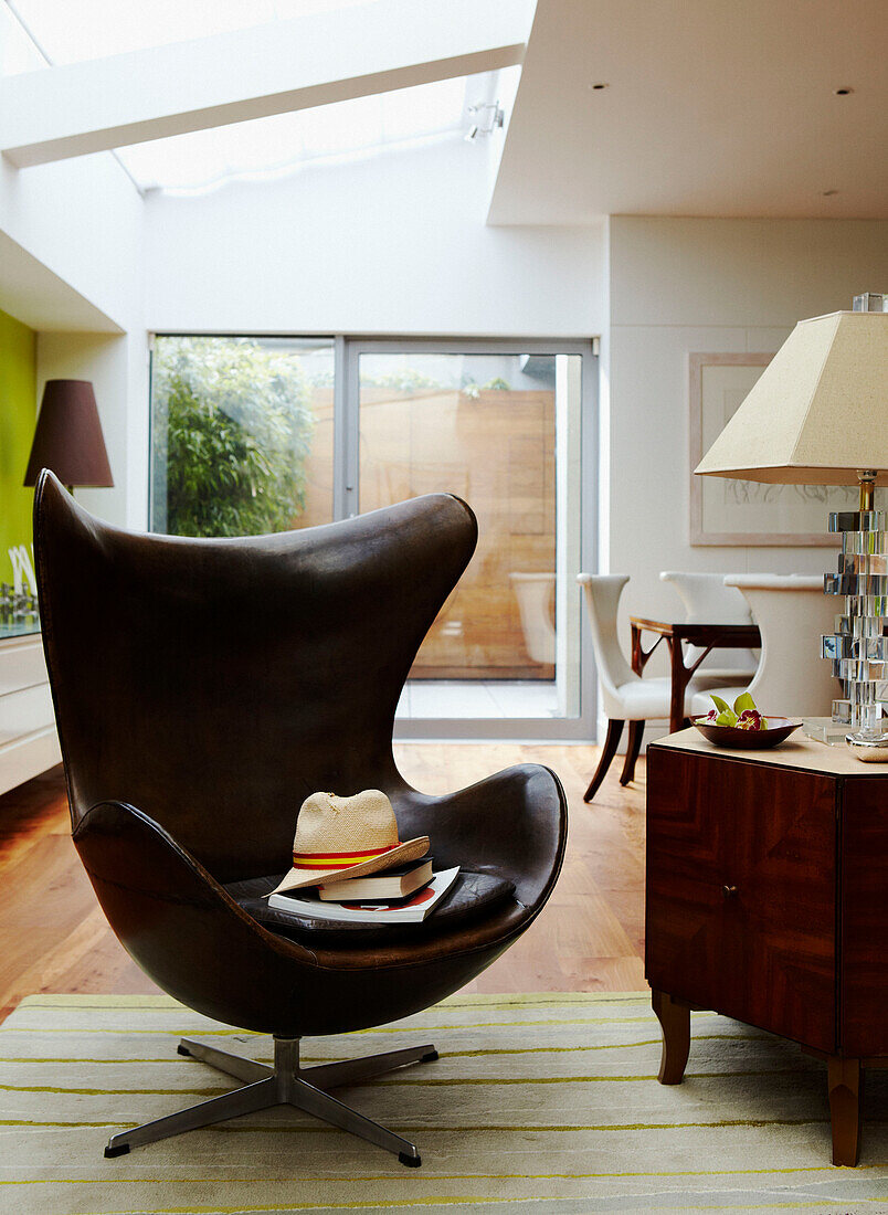 Brown leather armchair with sunhat in open plan apartment 