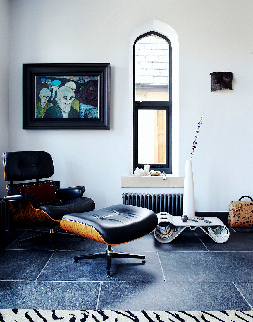 Black leather armchair and footstool in Richmond school church conversion