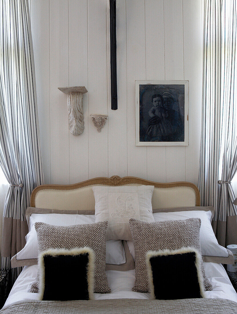 Headboard and cushions in bedroom of Edwardian school house conversion