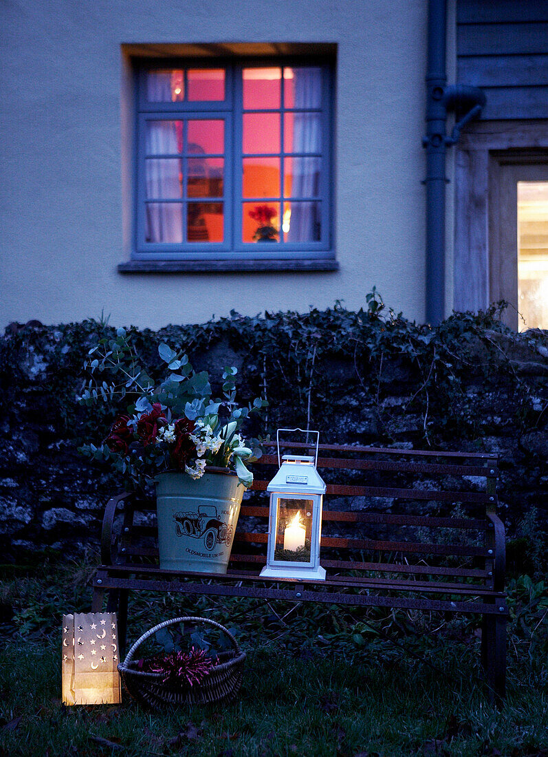 Bucket of cut flowers and lantern outside a 16th Century Welsh farmhouse