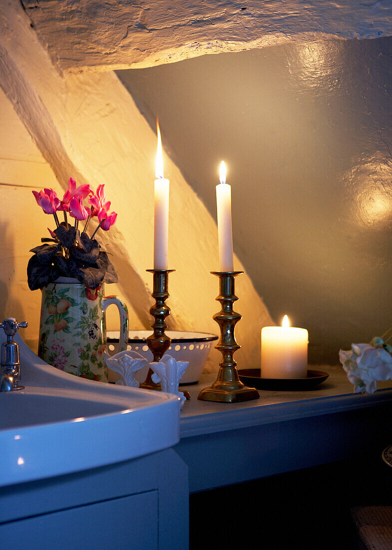 Lit candles by wash basin in 16th Century Welsh farmhouse cottage