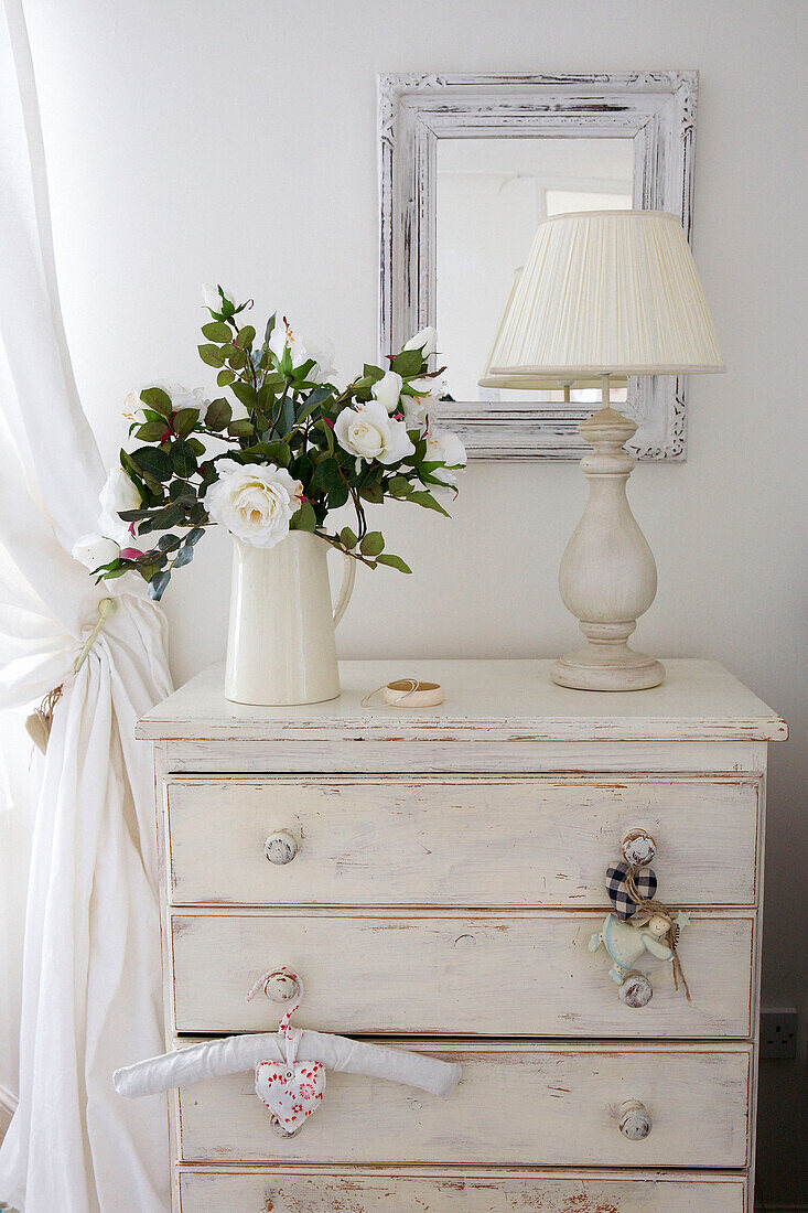 Wild roses and lamp on salvaged chest of drawers