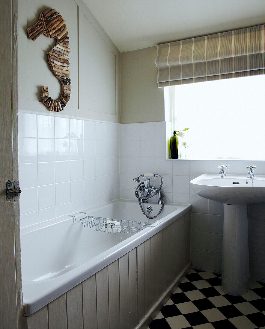 Wooden seahorse in neutral panelled bathroom