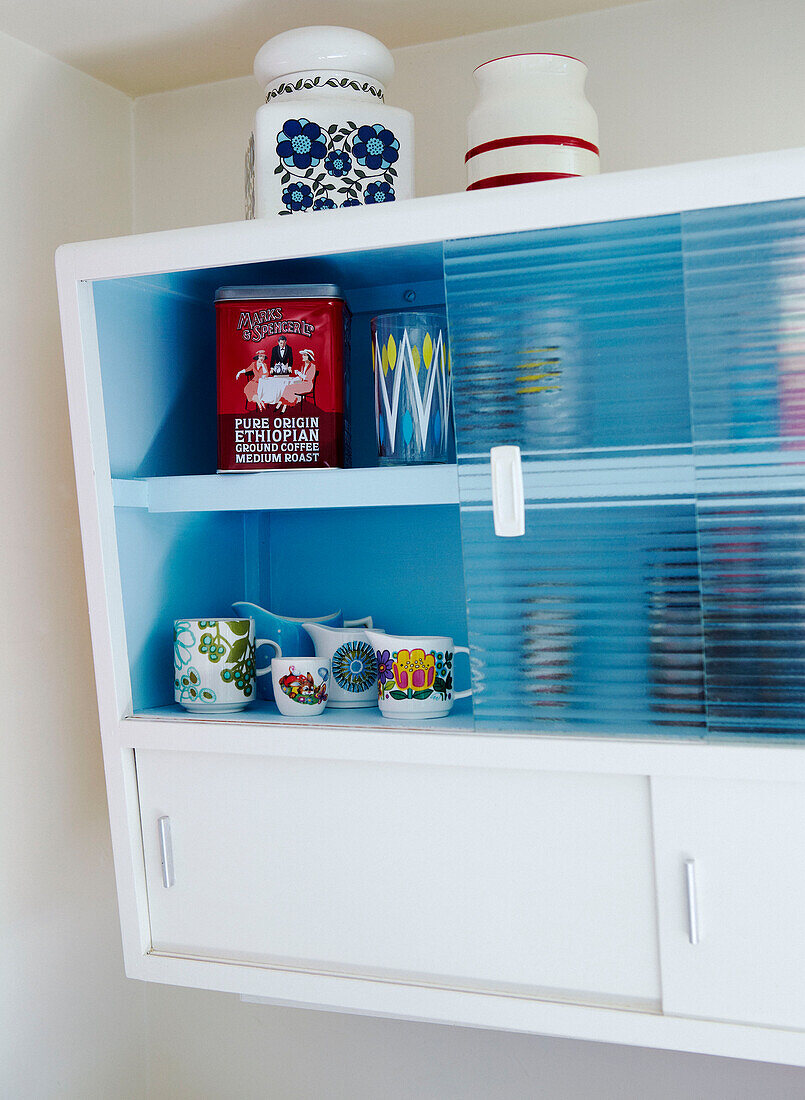 Wall mounted glass fronted cabinet in 1950s kitchen