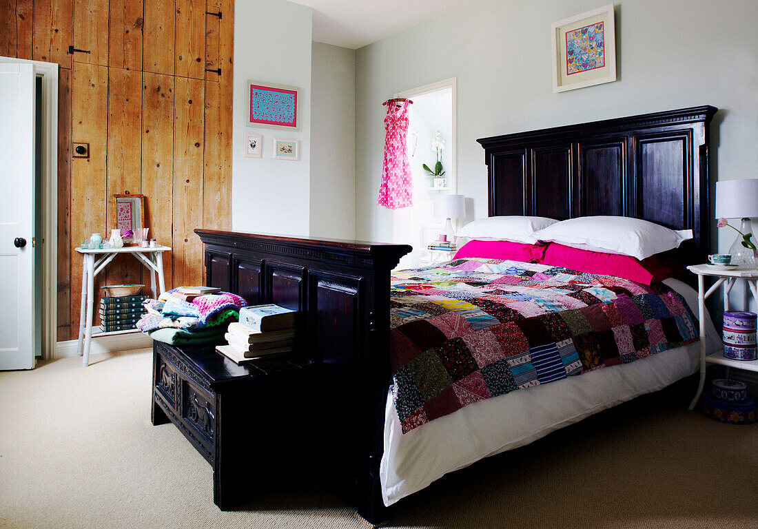 Patchwork quilt on black painted bed