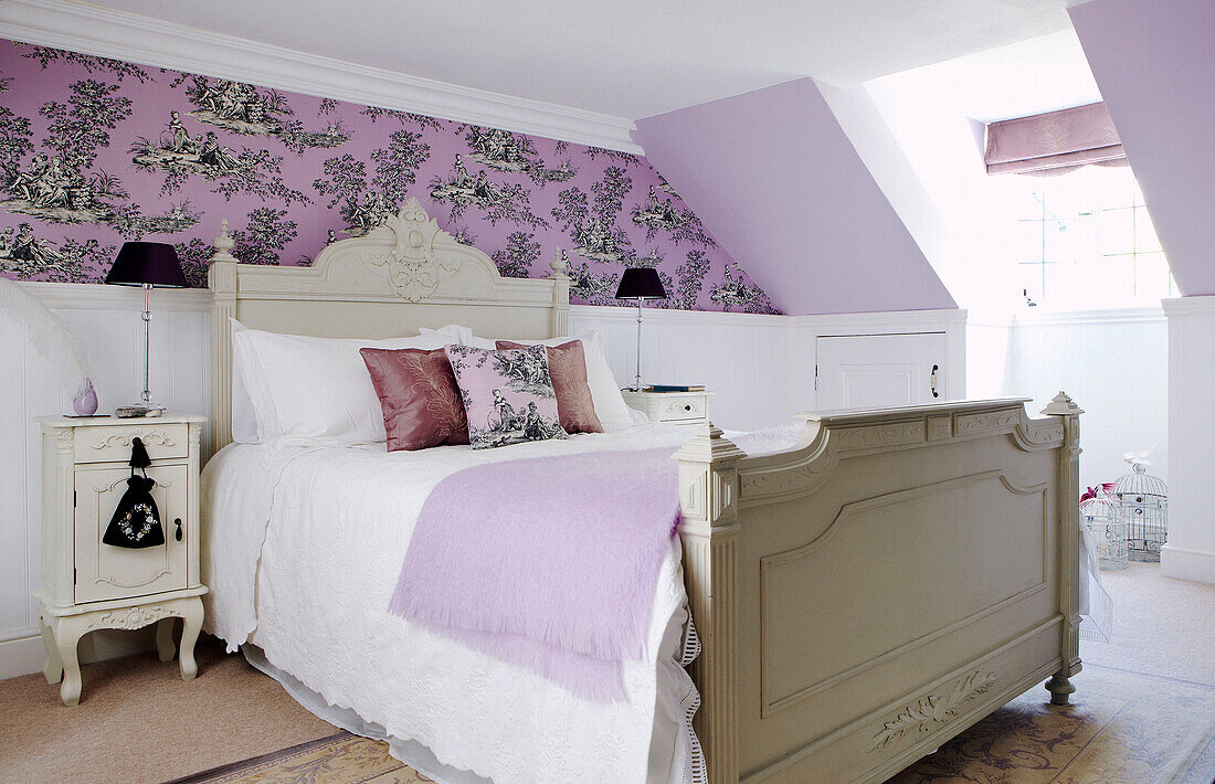Attic bedroom with patterned wallpaper and dormer window