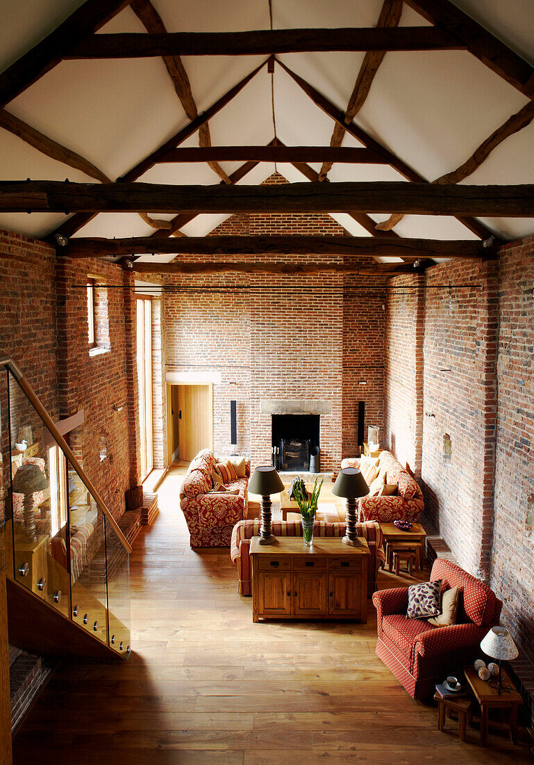 Sitting room with high ceiling and beams in renovated barn