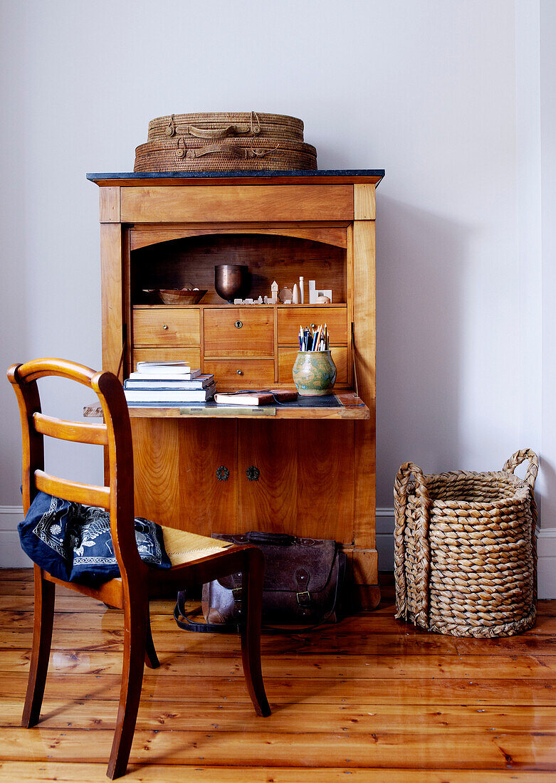 Natural fibre baskets at writing bureau with chair in London home
