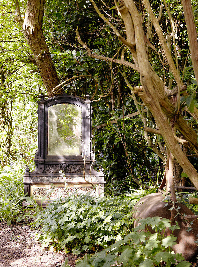 Mirror on stone plinth in garden