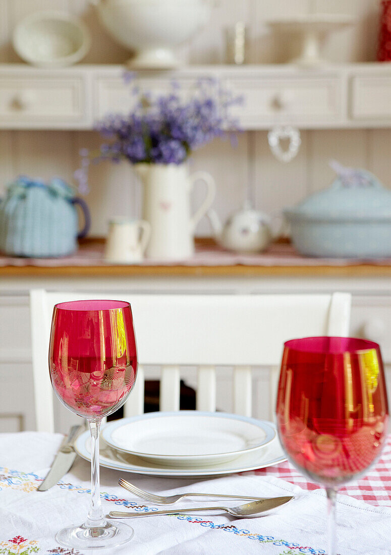 Red wineglasses on table in family home