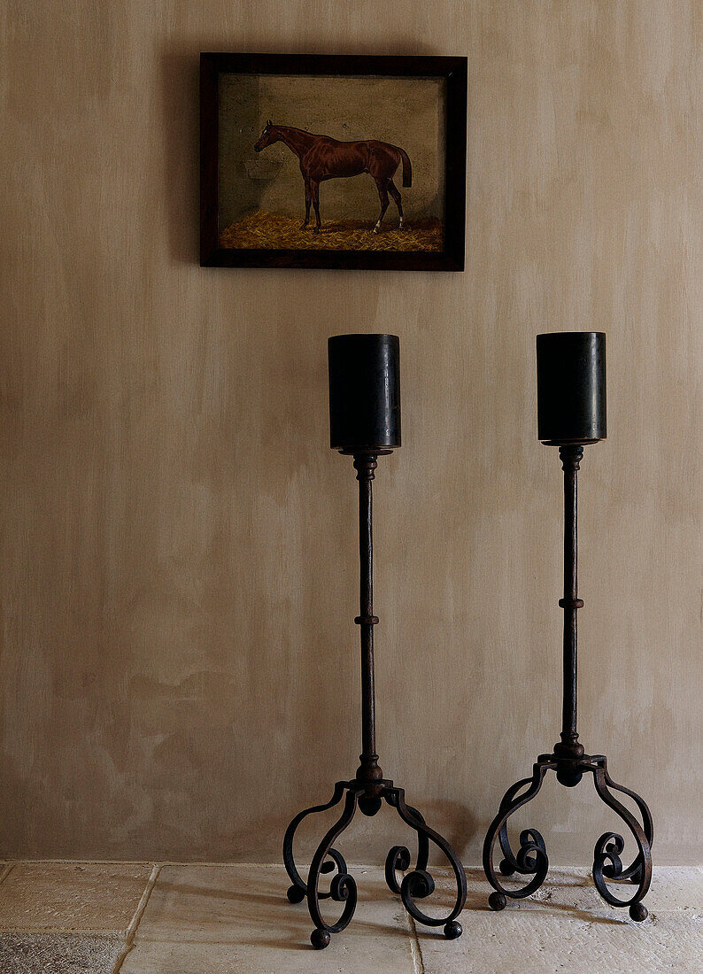 Wrought iron candle holders and equestrian artwork in country home