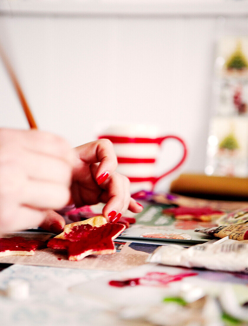 Woman making red stars at Christmas