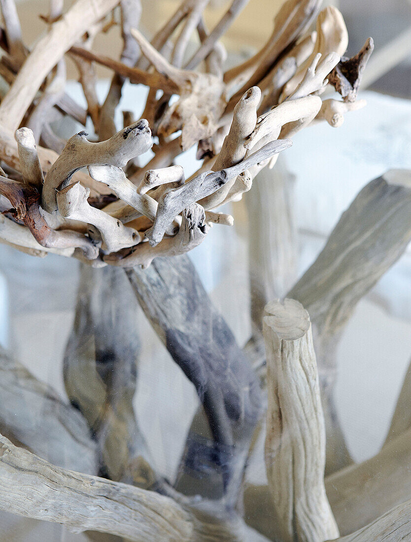 Driftwood basket on glass table in Hampshire home England UK
