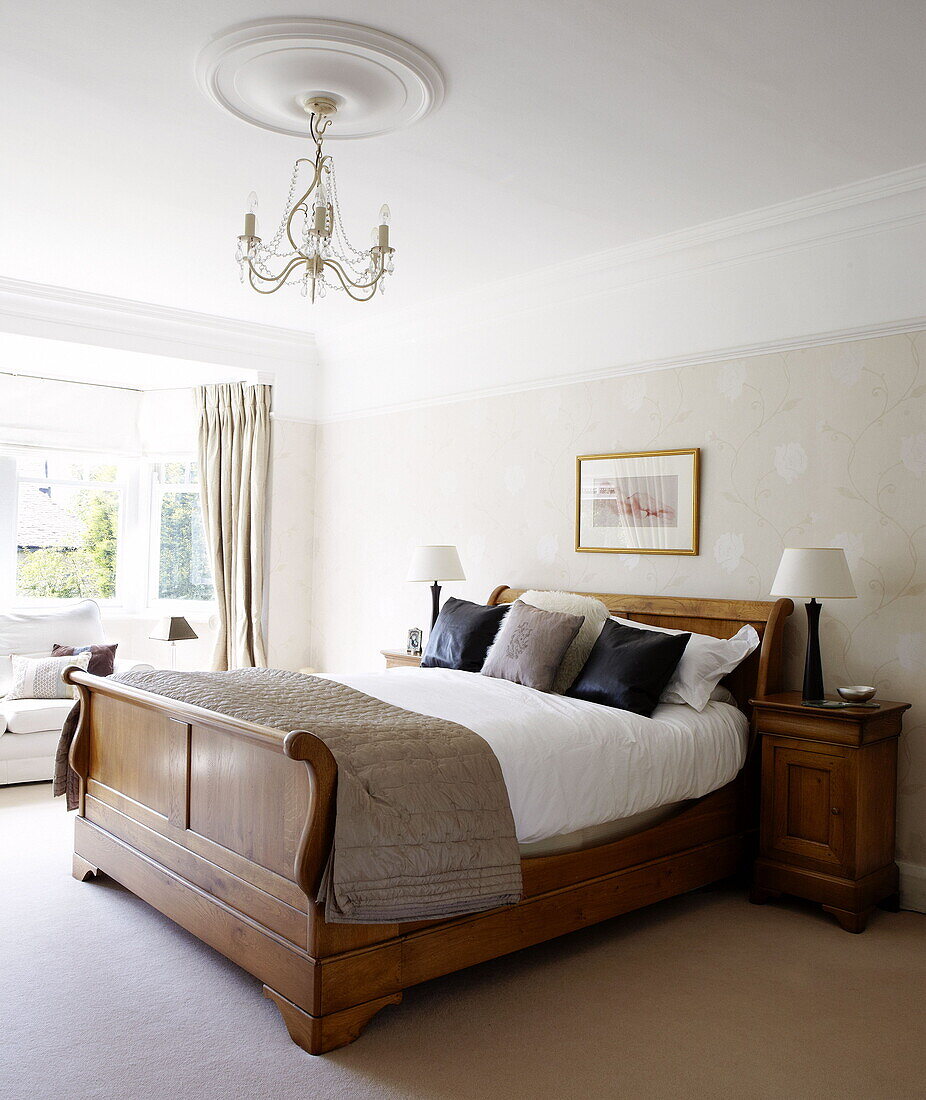 Double sleigh bed in bedroom of Harrogate home Yorkshire England UK