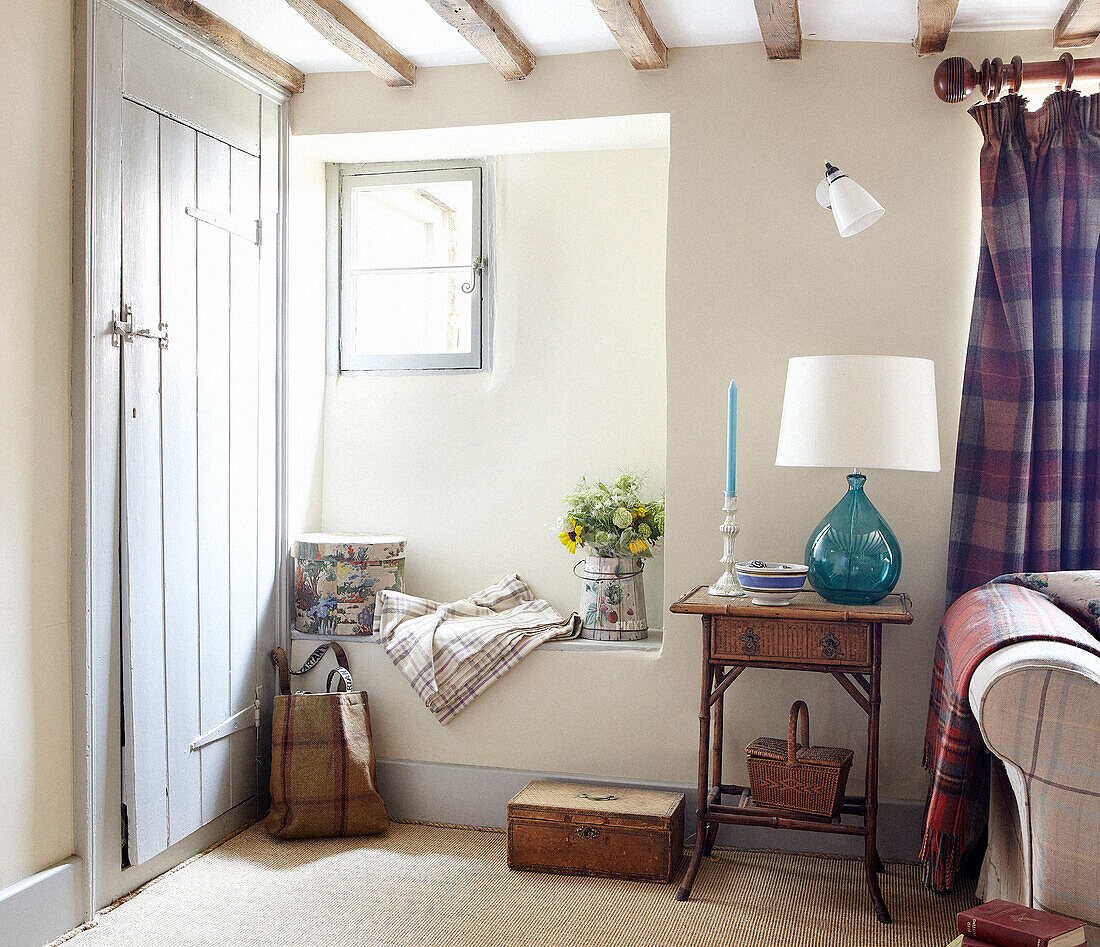 Sunlit window seat and side table in Oxfordshire farmhouse, England, UK