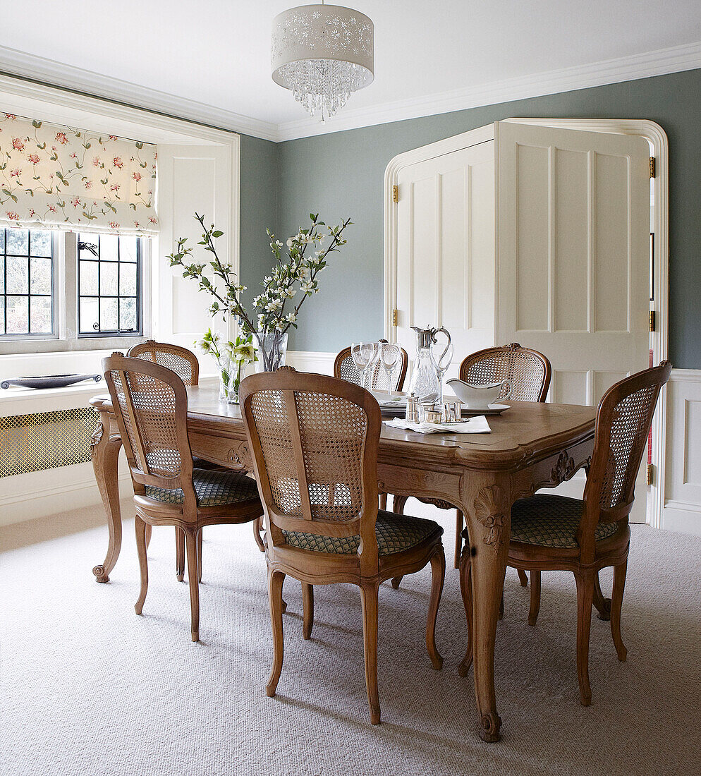 Antique dining table with spring blossom in Oxfordshire home, England, UK