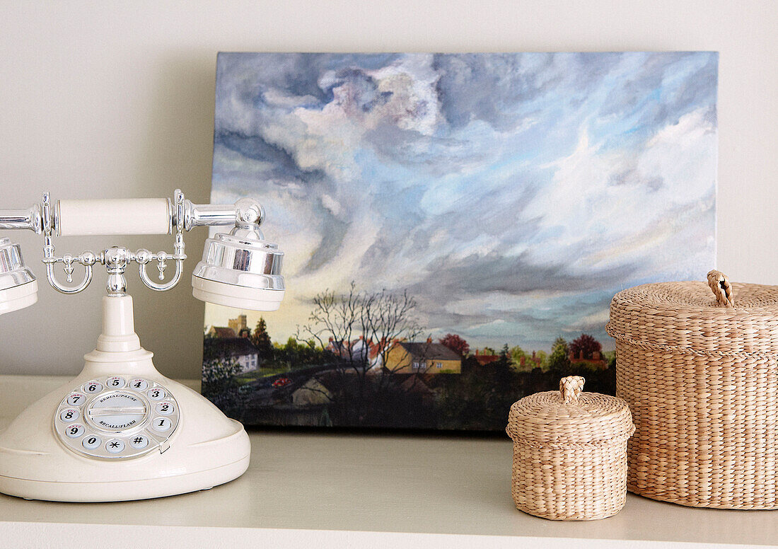 Vintage telephone and oil painting with baskets in Oxfordshire home, England, UK