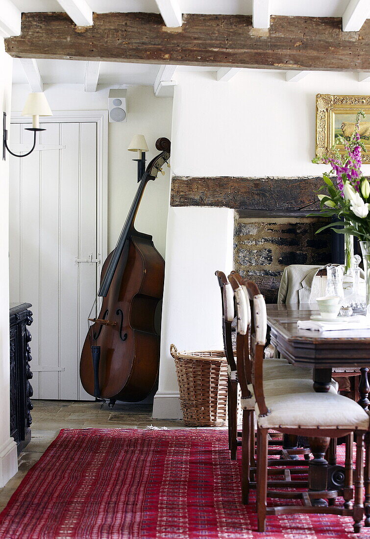 Double bass in dining room of Oxfordshire farmhouse, England, UK