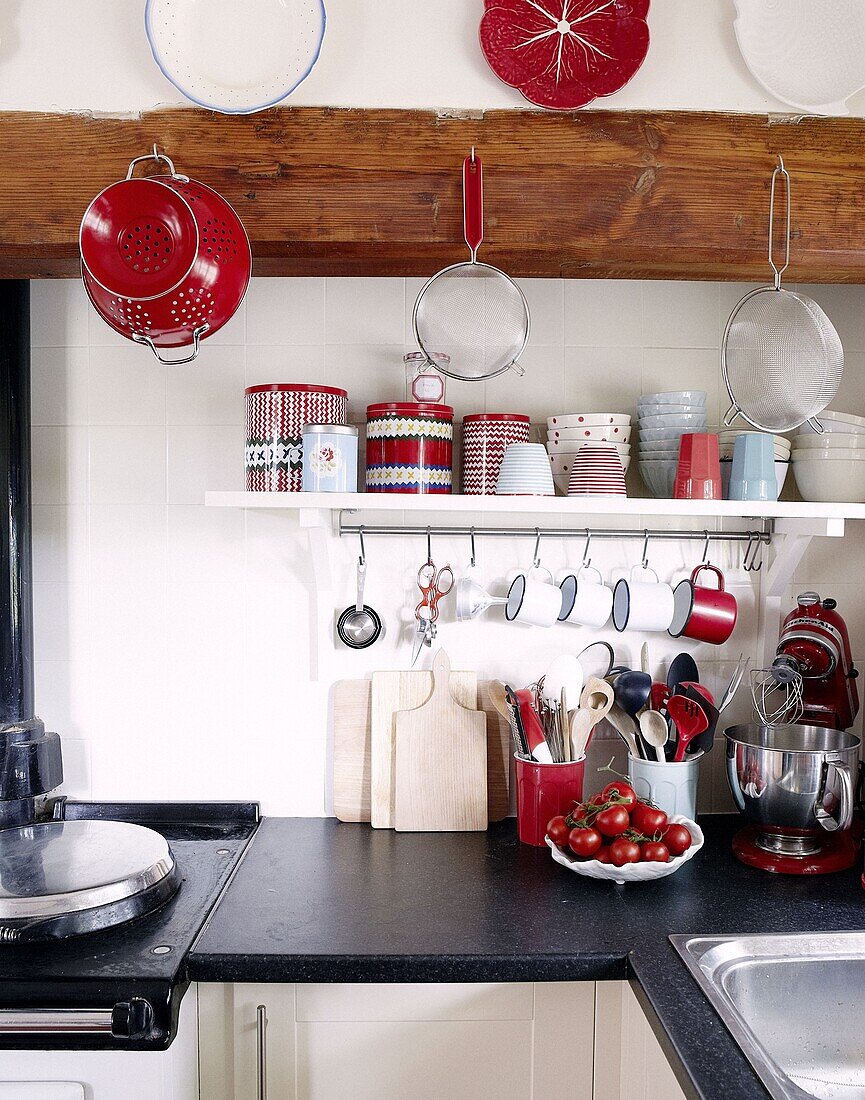 Kitchenware and utensils on black worktop in contemporary cottage kitchen, Staffordshire, England, UK