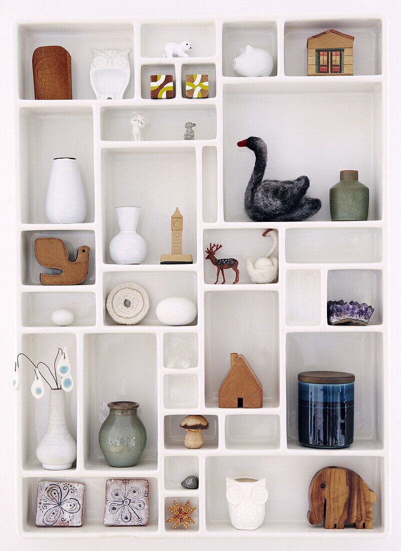 Selection of ornaments in wall shelf in Bussum home, Netherlands
