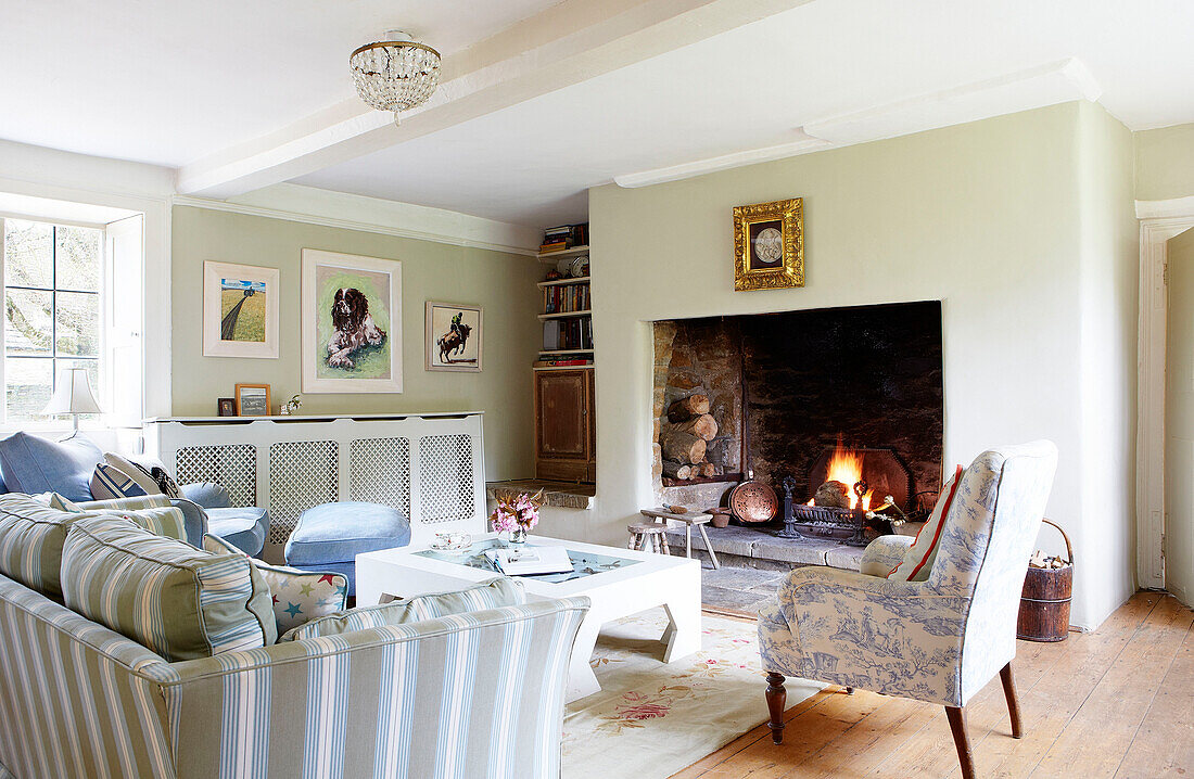 recessed fire lit in living room of Oxfordshire farmhouse England UK