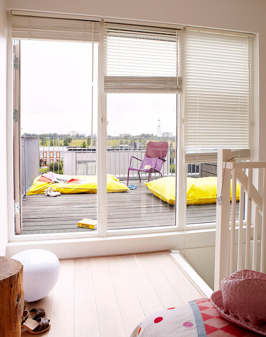 view through doorway to airbeds on outdoor terrace of Mattenbiesstraat family home, Netherlands