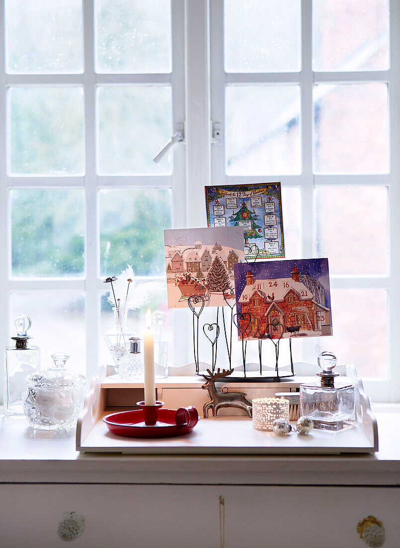 Christmas cards and candles on sideboard at window of Derbyshire farmhouse England UK
