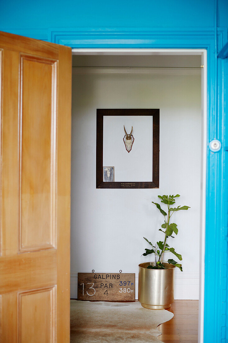 View through wooden doorway to hall with picture frame in Auckland home North Island New Zealand