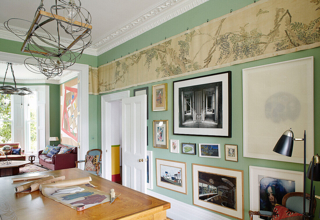 Vintage wallpaper above framed artwork in drawing room of Notting Hill home West London UK