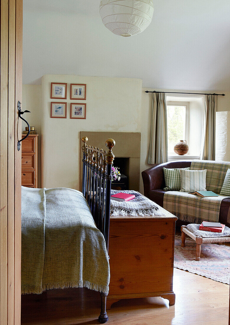 Deckenkasten aus Holz und Trittbrett aus Messing in einem Schlafzimmer in einem Bauernhaus in Derbyshire, England, UK