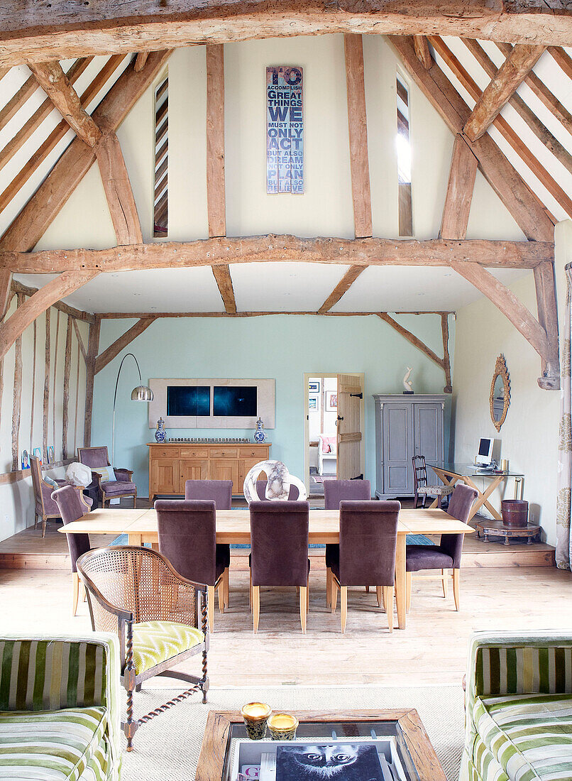 Open plan timber framed living and dining room of Nottinghamshire barn conversion England UK